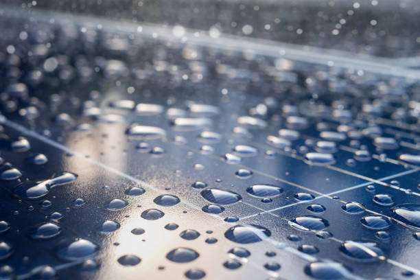 Raindrops on a solar panel surface, highlighting durability of outdoor solar light systems.
