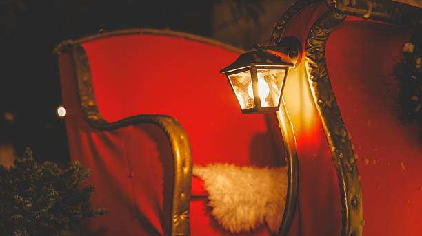 Festive red sleigh with a cozy fur blanket and a classic, warm glowing wall light.