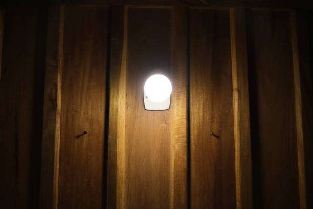 Close-up of a single outdoor solar light mounted on wood.