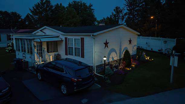 Suburban home at dusk with decorative stars and a charming outdoor Wall Light.